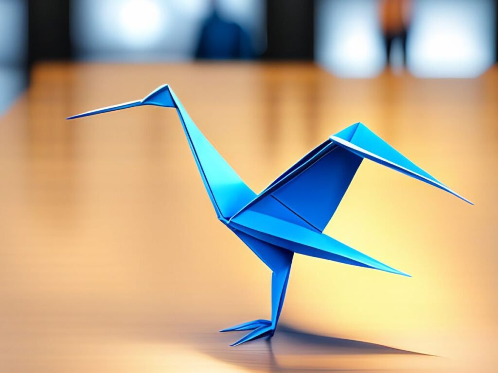 Blue Origami crane on a desk with a blurred background